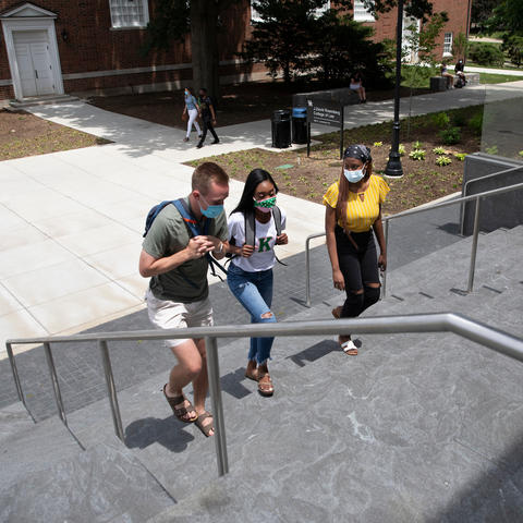 photo of students walking up the outside steps of the Rosenberg College of Law.