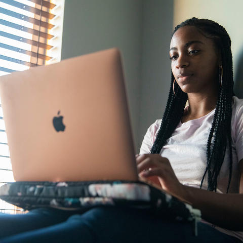 photo of UK student in residence hall on laptop