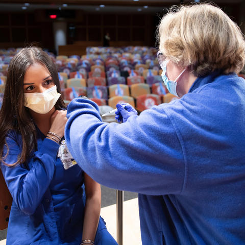ER nurse Hinali Patel (left) gets her vaccination from Joni Pruitt (right) as UK administered its first round of COVID-19 vaccinations on December 15, 2020.