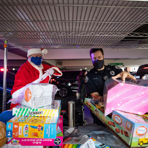 photo of UK Police Chief Joe Monroe dressed as Santa and UK Police Sgt. Wesley Tyler unloading toys for Kentucky Children's Hospital patients.