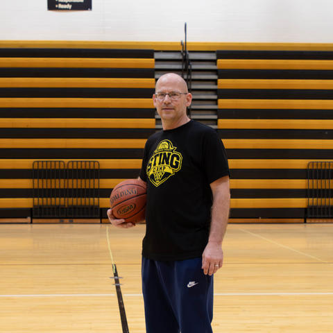 image of Dan Zuber holding a basketball in the center of a basketball court