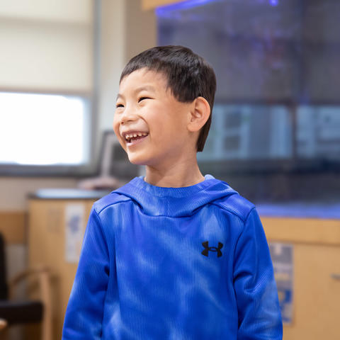 Image of boy in blue hoodie, smiling