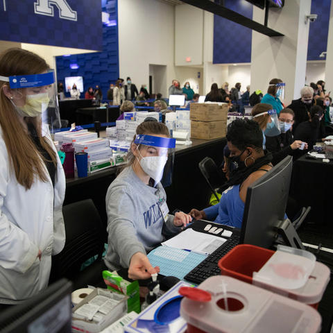 Photo of volunteers working at COVID-19 vaccine clinic at Kroger Field