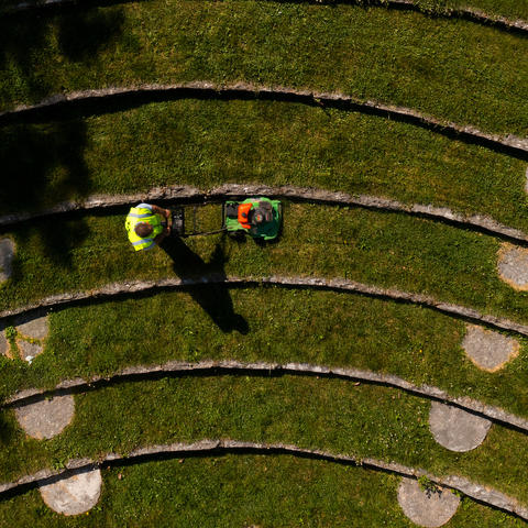 Aerial photo of two people mowing.