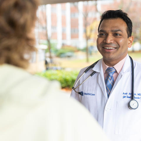 Image of Dr. Amit Arbune chatting with patient