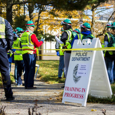 UKPD to host training. Image of police and fire in yellow vests conducting a training outside.