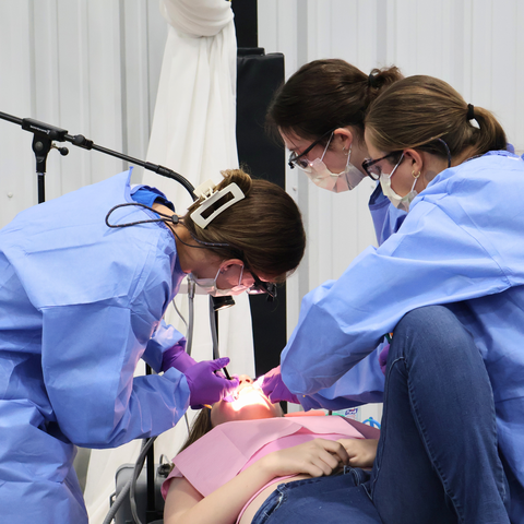 Dental students working on a patient