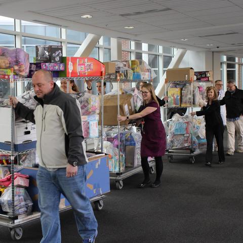 Members of the Ard family and staff from Kentucky Children's Hospital transport the donations collected in Jon's memory.