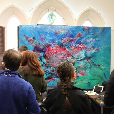 Photo of surgical residents viewing a painting