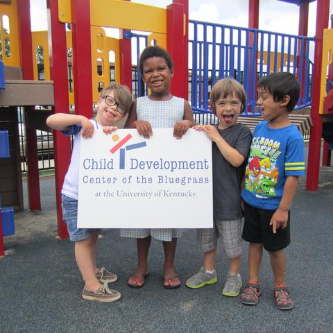 photo of kids holding Child Development Center of the Bluegrass sign