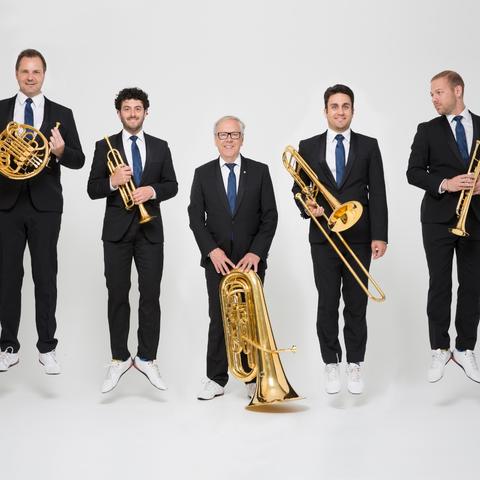 photo of Canadian Brass with instruments jumping