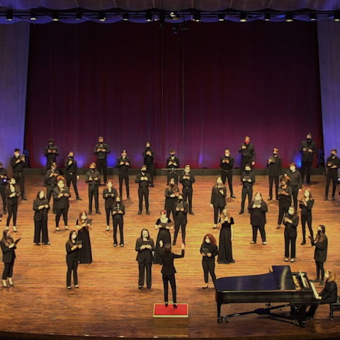 Photo of UK Choristers physically distanced on Singletary Center stage performing for virtual "Collage"