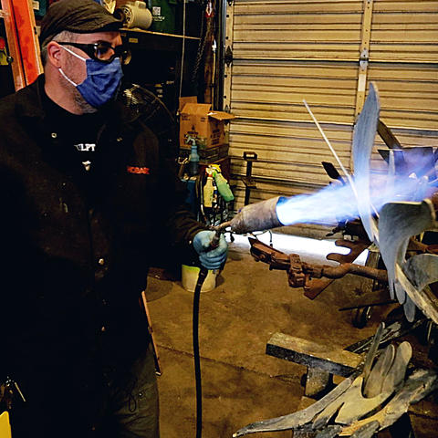 photo of Jeremy Colbert working on sculpture