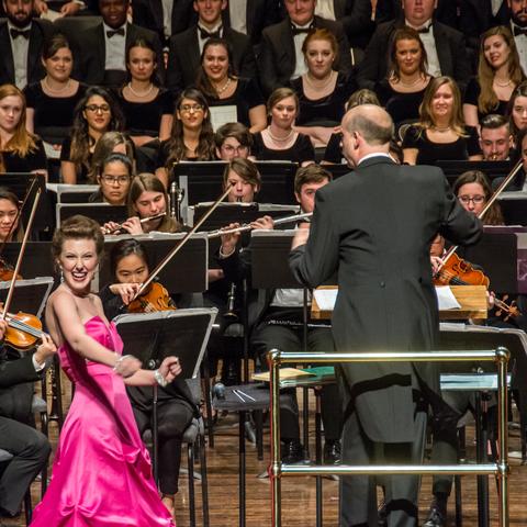 photo of vocalist performing before UK orchestra and choirs at Bernstein concert