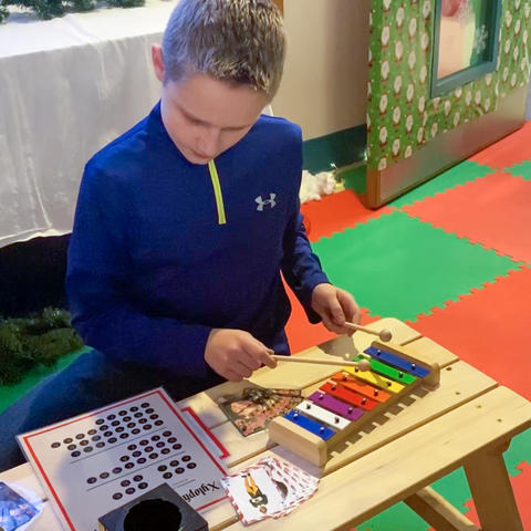 photo of dalton green playing toy xylophone