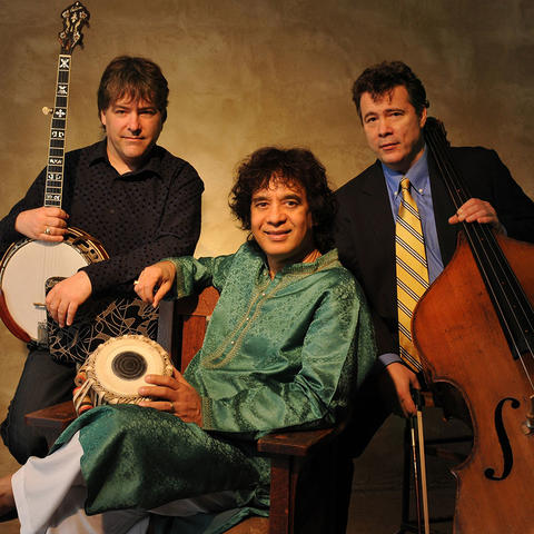 photo of Bela Fleck, Zakir Hussain (seated) and Edgar Meyer with instruments