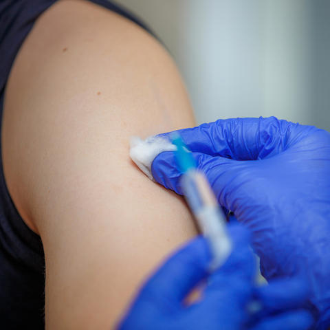 photo of person receiving a flu shot in the arm