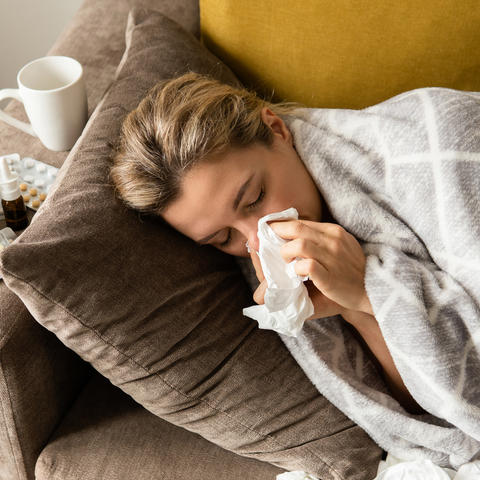 A woman blows her nose