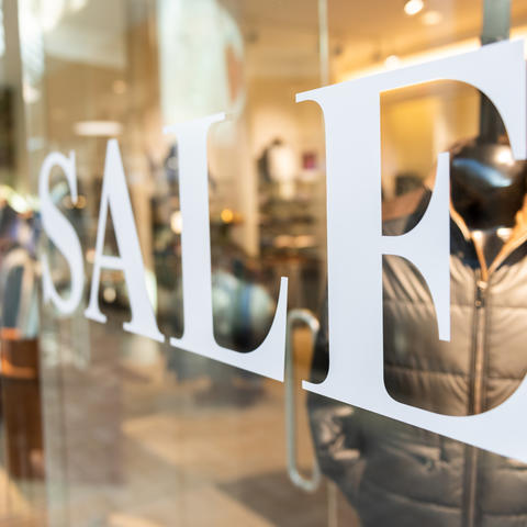 Photo of SALE sign on shop window.