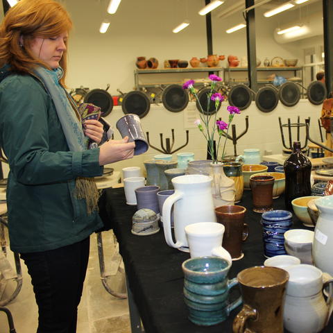 photo of lady looking at ceramic vase at Open Studio 2017