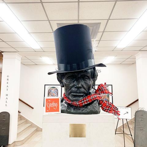 photo of Abe Lincoln bust in King Library with scarf and stovetop hat