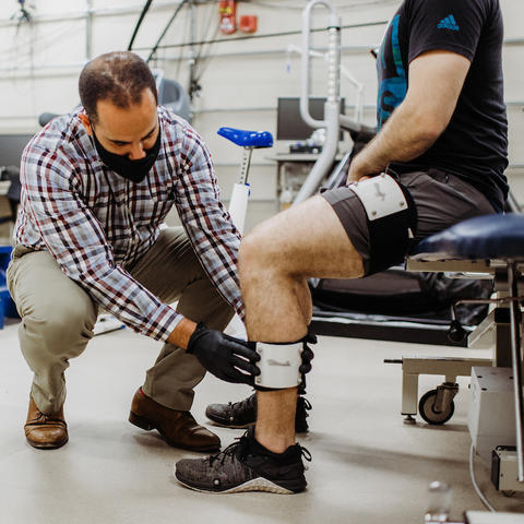 a physician giving a patient treatment in a physical rehabilitation center.