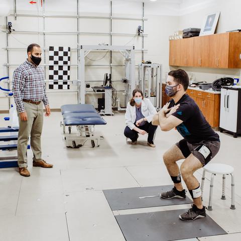 Michael Samaan (left) and Mary Sheppard (center) prepare for the study in the UK Biodynamics Lab with graduate assistant Walter Menke (right). 