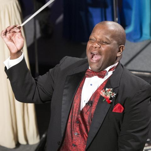 photo of Everett McCorvey conducting and singing at 2016 Celebration of Song