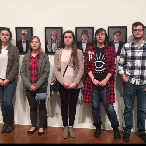 photo of operations team from "Art Entrepreneurship" class with portraits from "Saving Myself" by Louis Zoellar Bickett