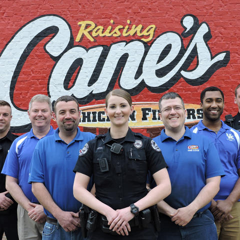 photo of UK Police officers and Raising Cane's personnel