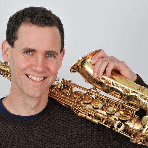 headshot photo of Rick Hirsch with saxophone by Meadowlane Photography