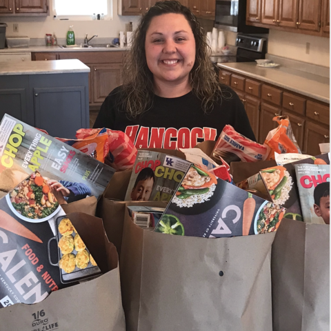 Bethony Morris standing with bags of food