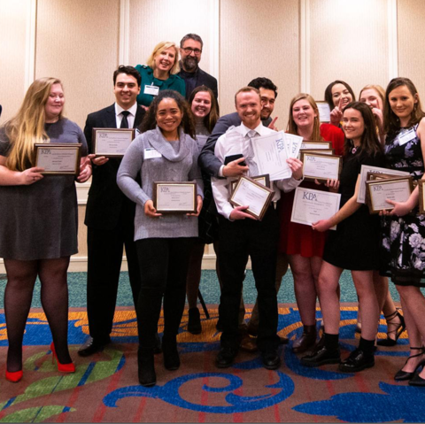 The Kentucky Kernel staff celebrate winning the KPA General Excellence Award for Large Collegiate Papers in January 2020, the last time they were able to celebrate awards together before the pandemic began.