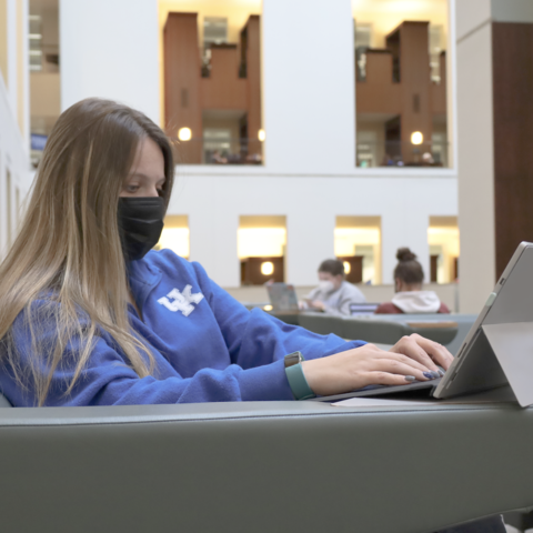 Student using tablet device in William T. Young Library on UK campus