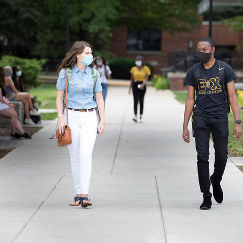 students walking on campus in masks