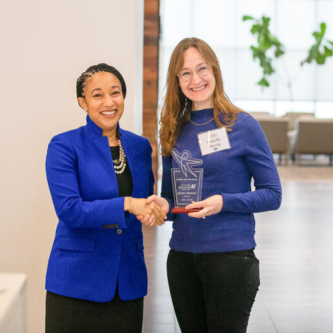 UK College of Education Acting Dean Danelle Stevens-Watkins, left, presents a Teachers Who Made a Difference Award at the February 2024 recognition ceremony. 