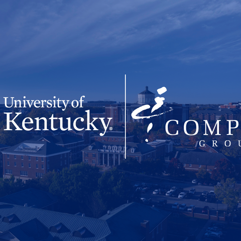  Kentucky and Compass Group logos over a blue‑tinted aerial view of campus buildings