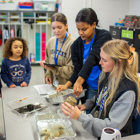 UK College of Education students Lily Nowka, Erris Pierson, and Zoey Holland work with students during unit day at Breckinridge Elementary