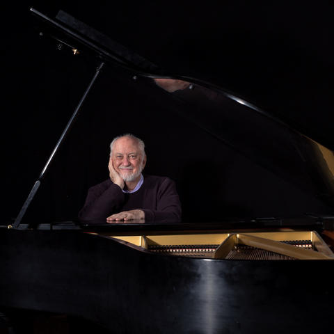photo of Wayland Rogers seated at grand piano by Jerry Alt