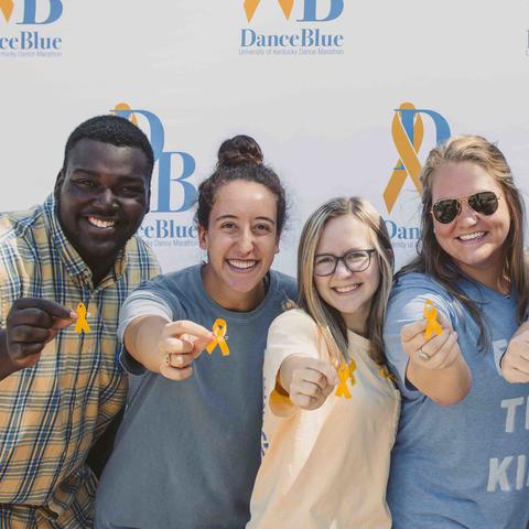 DanceBlue volunteers hold out yellow ribbons