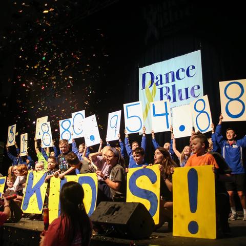 DanceBlue participants hold up fundraising total