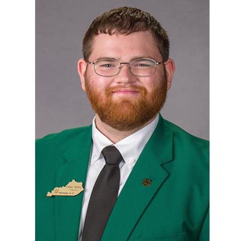 Headshot of UK senior Dylan Gentry pictured in green jacket with black tie