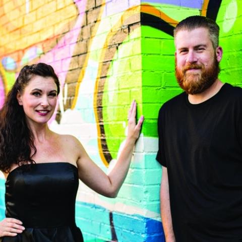 photo of Jessica and John Winters by PRHBTN mural