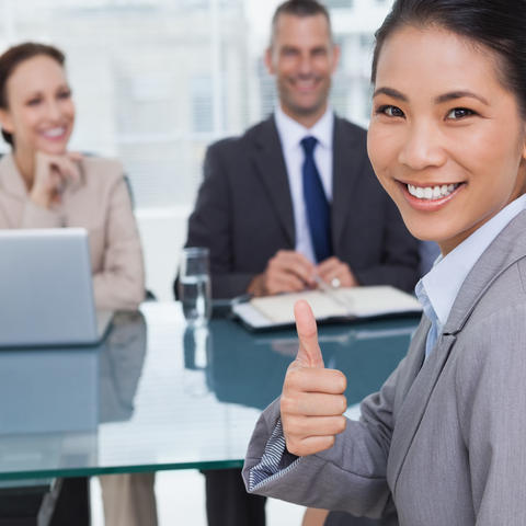 stock photo of job candidate at interview giving thumbs up