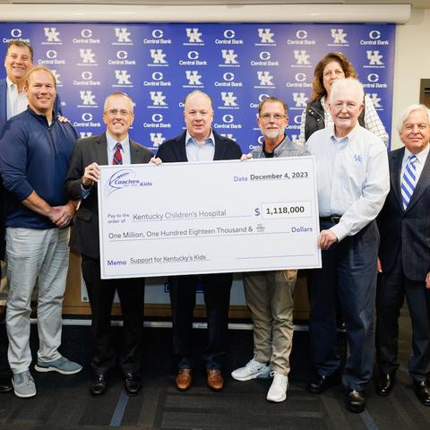 image of group of people with a check made out to KCH for over $1 million