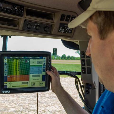 Chad Lee, director of the UK Grain and Forage Center of Excellence, monitors the planting progress of the "Sacred Acre" of corn at UK. Photo by Ginny Gregory, Kentucky Distillers' Association