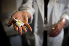 Doctor holding a naloxone dose in her hand. 