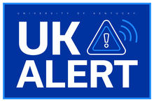 Blue rectangular graphic with large white text that reads ‘UK ALERT’ beside a triangular warning icon with an exclamation point and signal lines, representing the University of Kentucky emergency notification system.