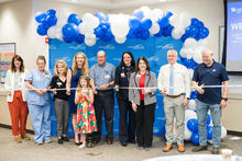 Image of group of people cutting a ribbon