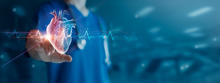 A doctor reaching out to a digital model of a heart and medical scan. 